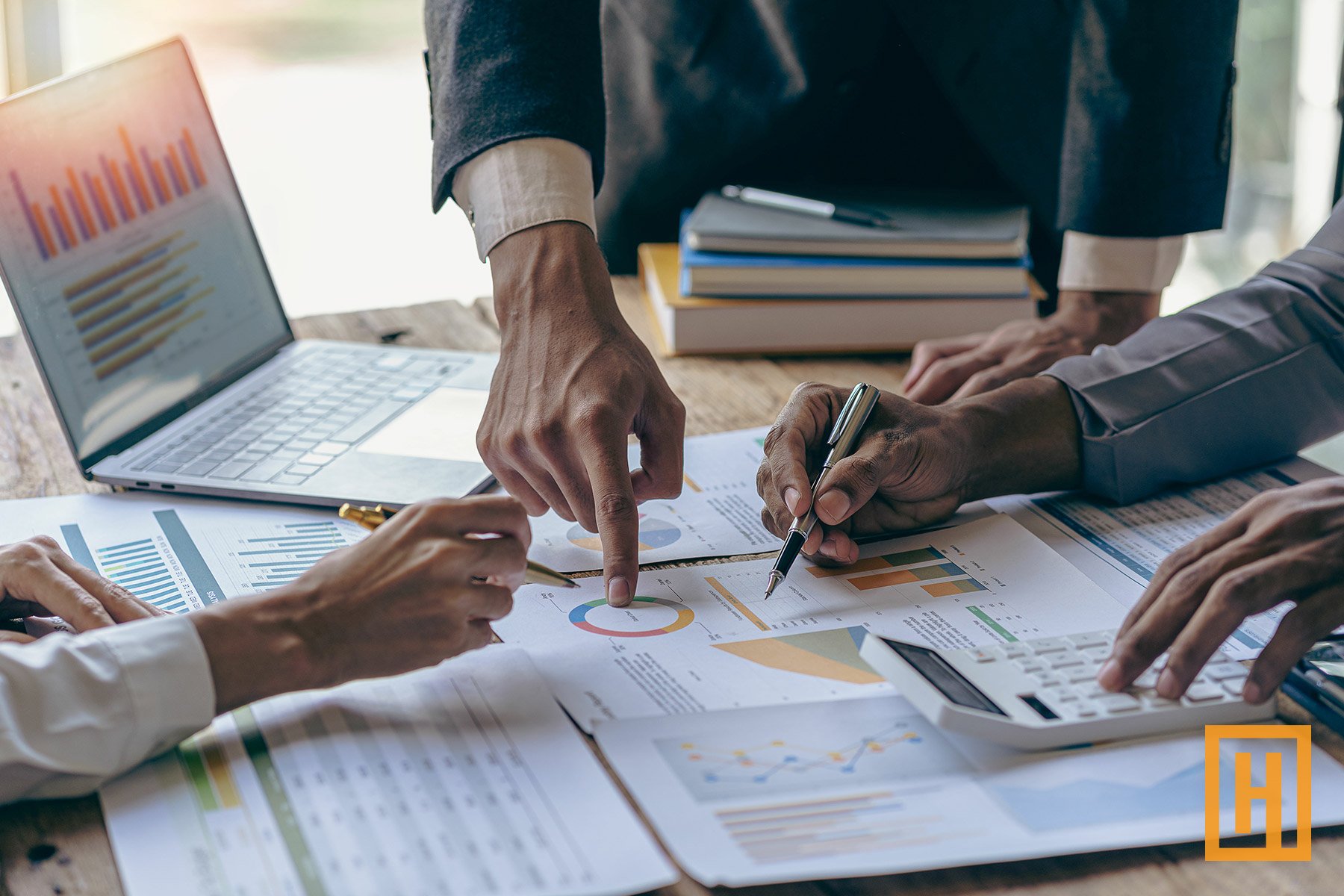 financial investors reviewing data on conference table