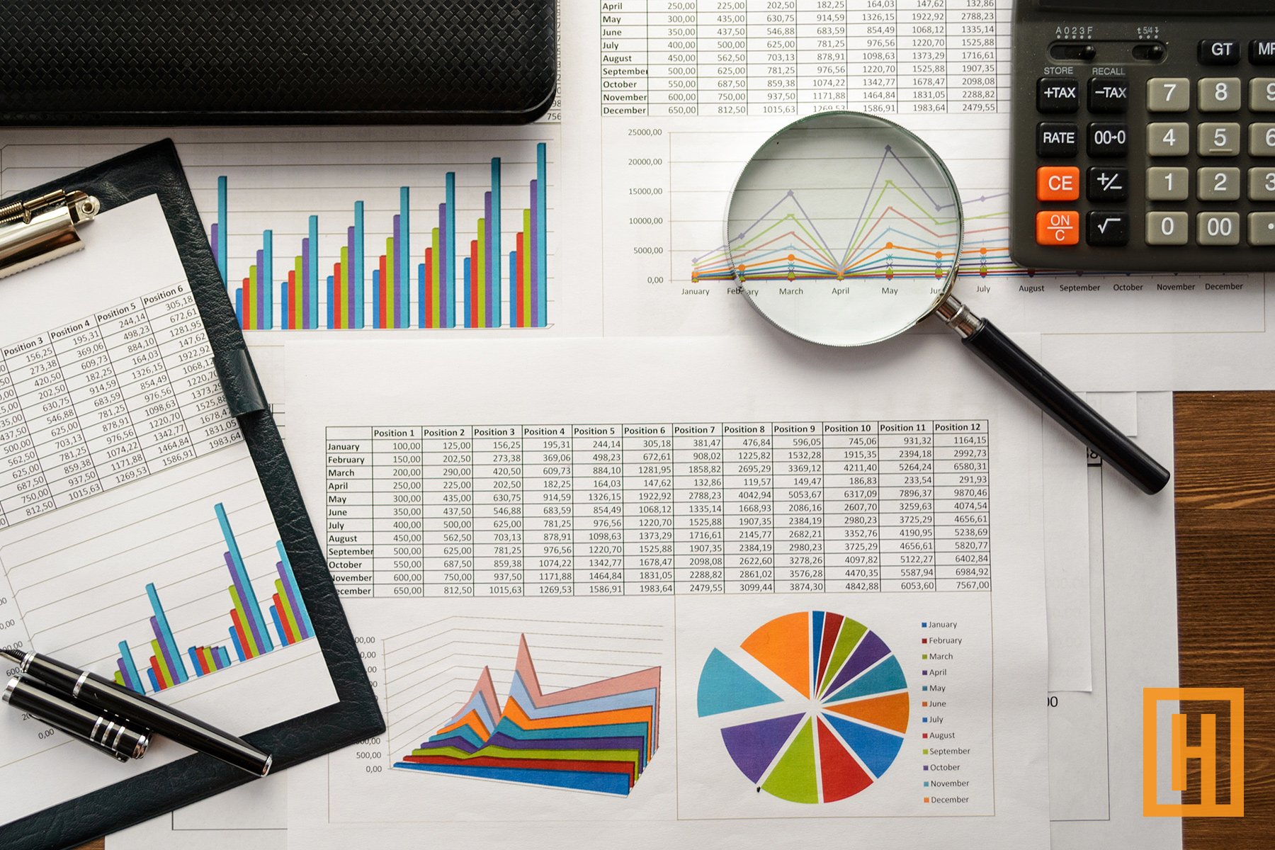 magnifying glass laid on top of charts