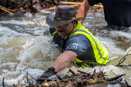 police officer walking through a flood