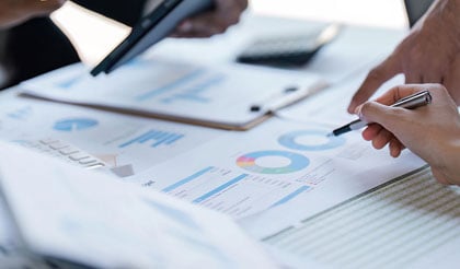 Professionals analyzing financial data and charts on a desk